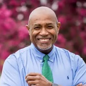 Portrait of Dr. Herb Conaway in business casual with cherry blossoms in the background.