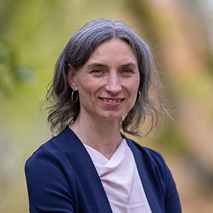 Portrait of Dr. Maxine Dexter wearing a cardigan outside.